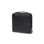 Black makeup bag with gold zipper on a white background