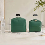 Two green standing makeup bags with measurements and a water bottle on a light surface.