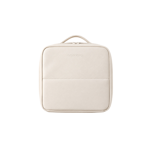A cream-colored faux leather travel pouch with a top handle, shown from a front-facing perspective on a solid white background.