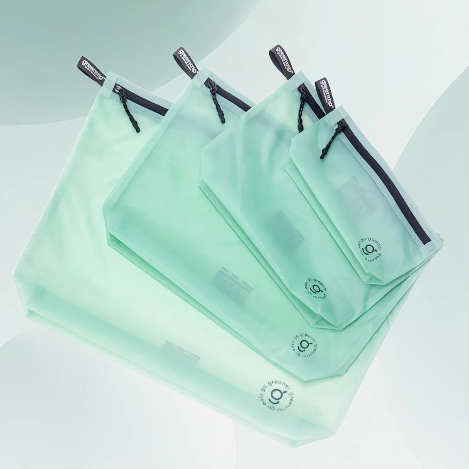Set of green travel storage bags with a brand logo on a light background
