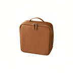 A brown pebbled leather cosmetic bag with a top handle and zippered closure, shown on a plain white background.