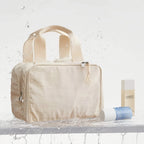 Beige toiletry bag with a bottle and tube on a light background