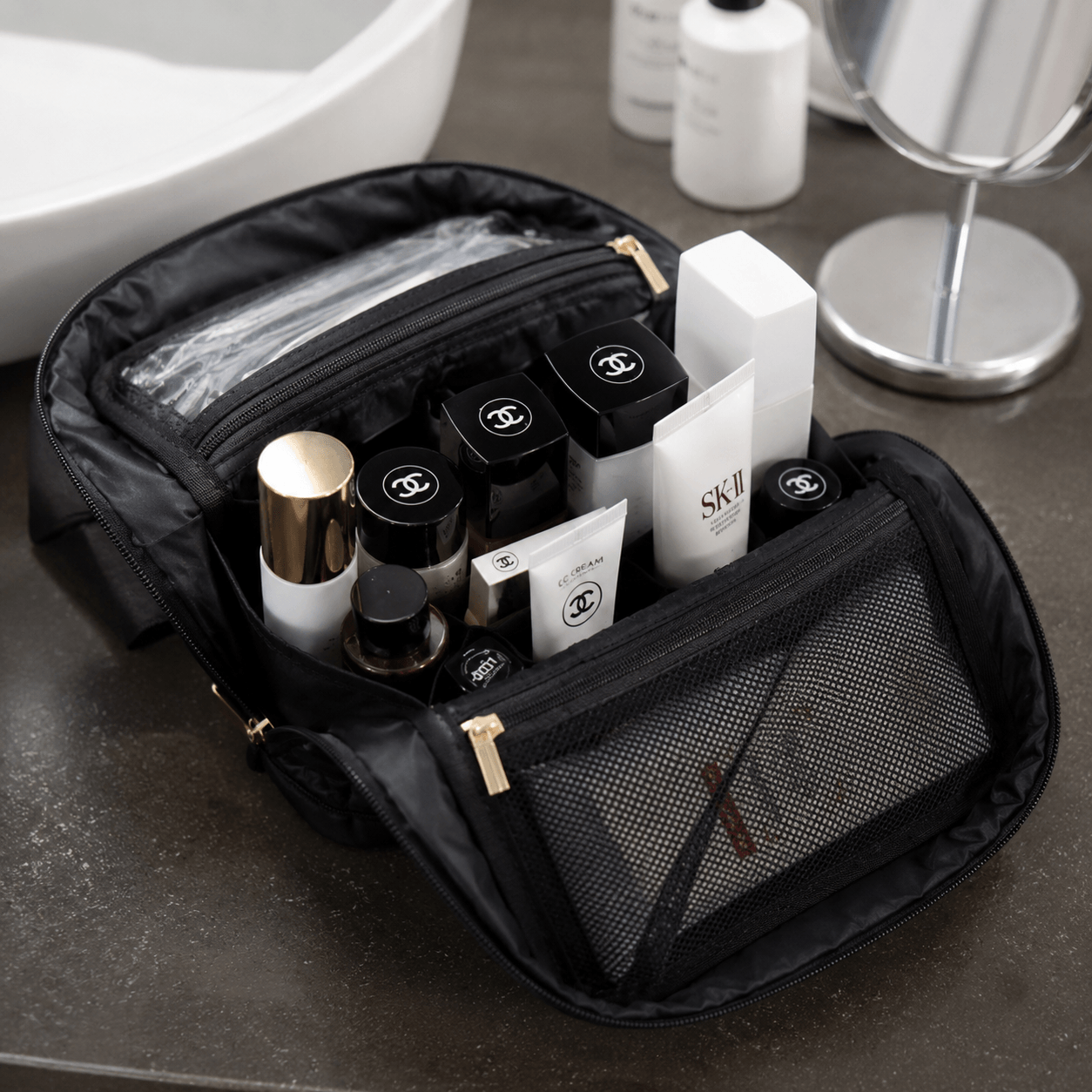 Black makeup bag with cosmetic products on a bathroom counter
