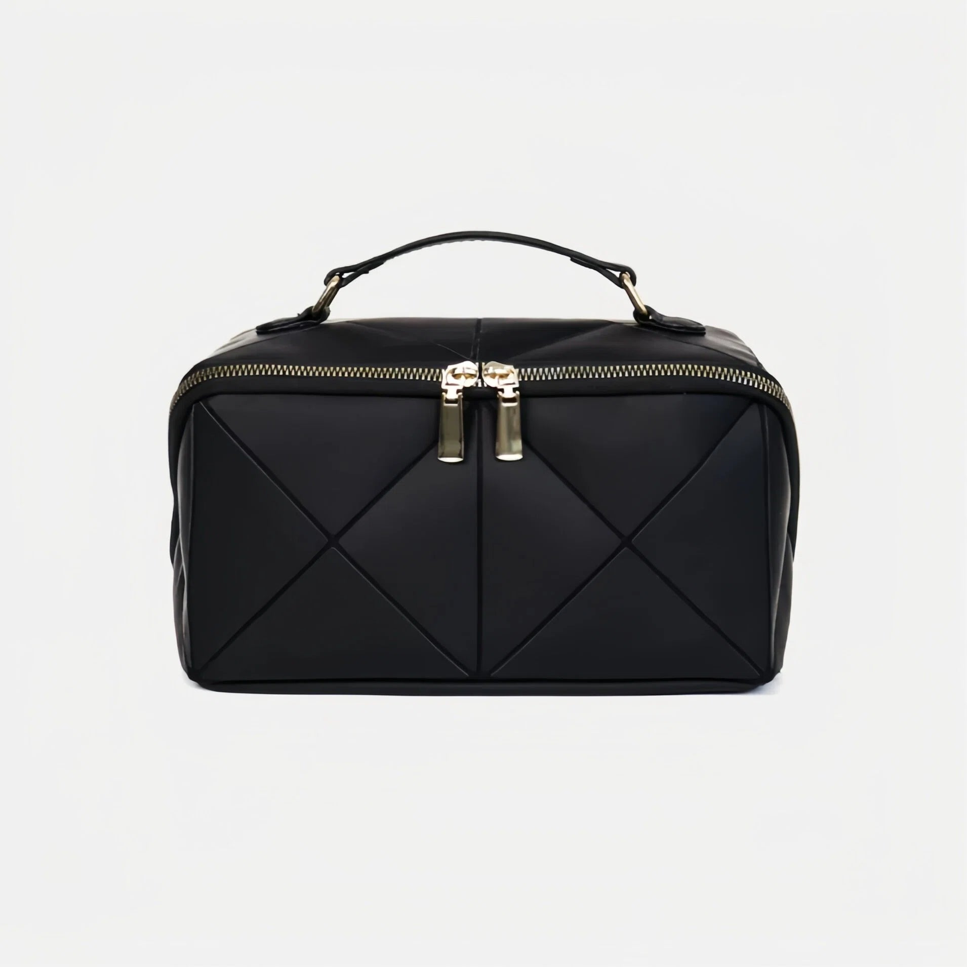 Black quilted makeup bag with gold zipper on a light gray background