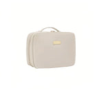 Beige cosmetic bag with a gold tag on a white background