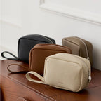 Makeup bags in four colours on a wooden surface