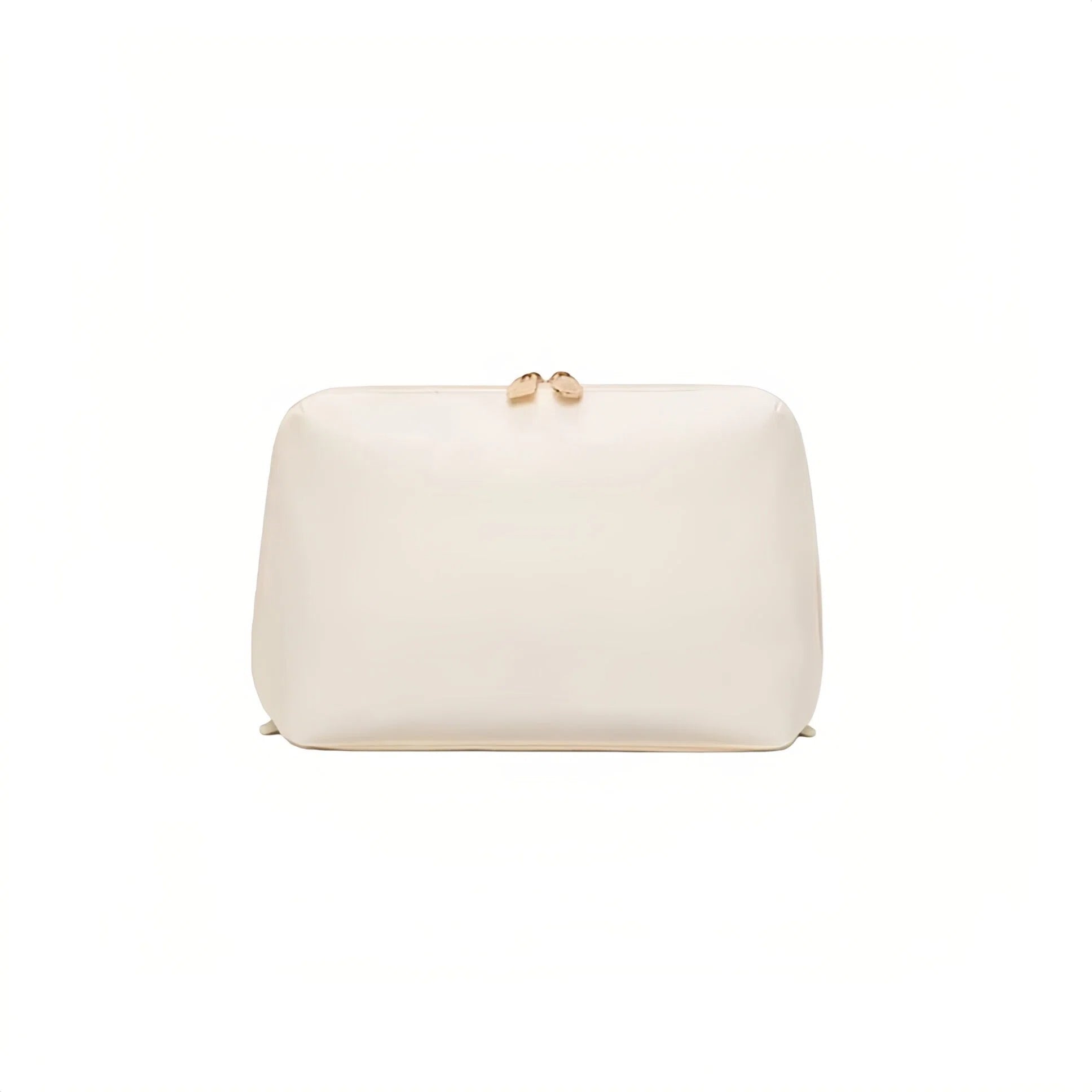 A cream cosmetic bag with a small gold bow detail on top, shown against a plain white background.