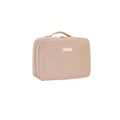 Pink travel case with a gold tag on a white background
