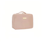 Pink travel case with a gold tag on a white background