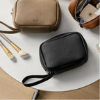 Olive grey and black makeup bags on a table