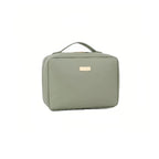 Green toiletry case with a gold tag on a white background