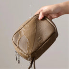 Olive grey makeup bag with water dripping down the side