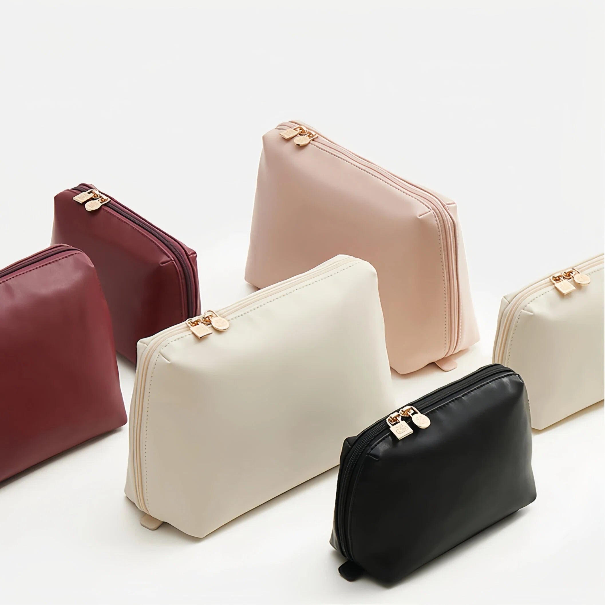 Set of four cosmetic bags in different colors on a white background