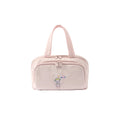 Pink toiletry bag with embroidery on a white background
