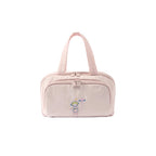 Pink toiletry bag with embroidery on a white background