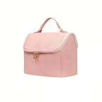 Pink toiletry bag with gold zipper on a white background