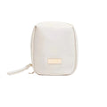 White cosmetic bag with a gold tag on a white background