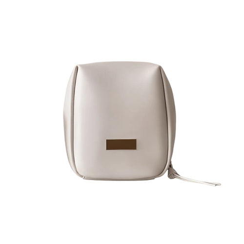 Beige pouch with a gold tag on a white background