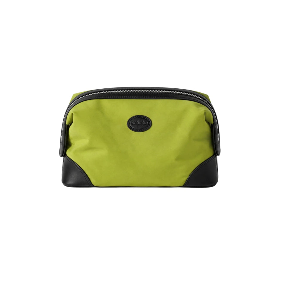 A lime green and black zippered cosmetic pouch with a black leather logo medallion on the front, set against a plain white background.