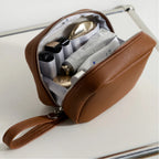 Brown makeup bag filled with makeup products