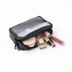 A grey cosmetic bag with a clear plastic top window, shown open with various makeup items like a compact mirror, perfume bottle, lipstick, and lip gloss peeking out, on a white background.