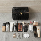 Black makeup bag with various cosmetic products on a gray surface