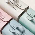 Four colorful makeup bags arranged in a row on a light background