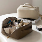 Cosmetic bag with makeup items on a table
