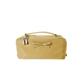 Yellow cosmetic bag with a bow on a white background