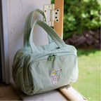 Green travel bag leaning against a door.