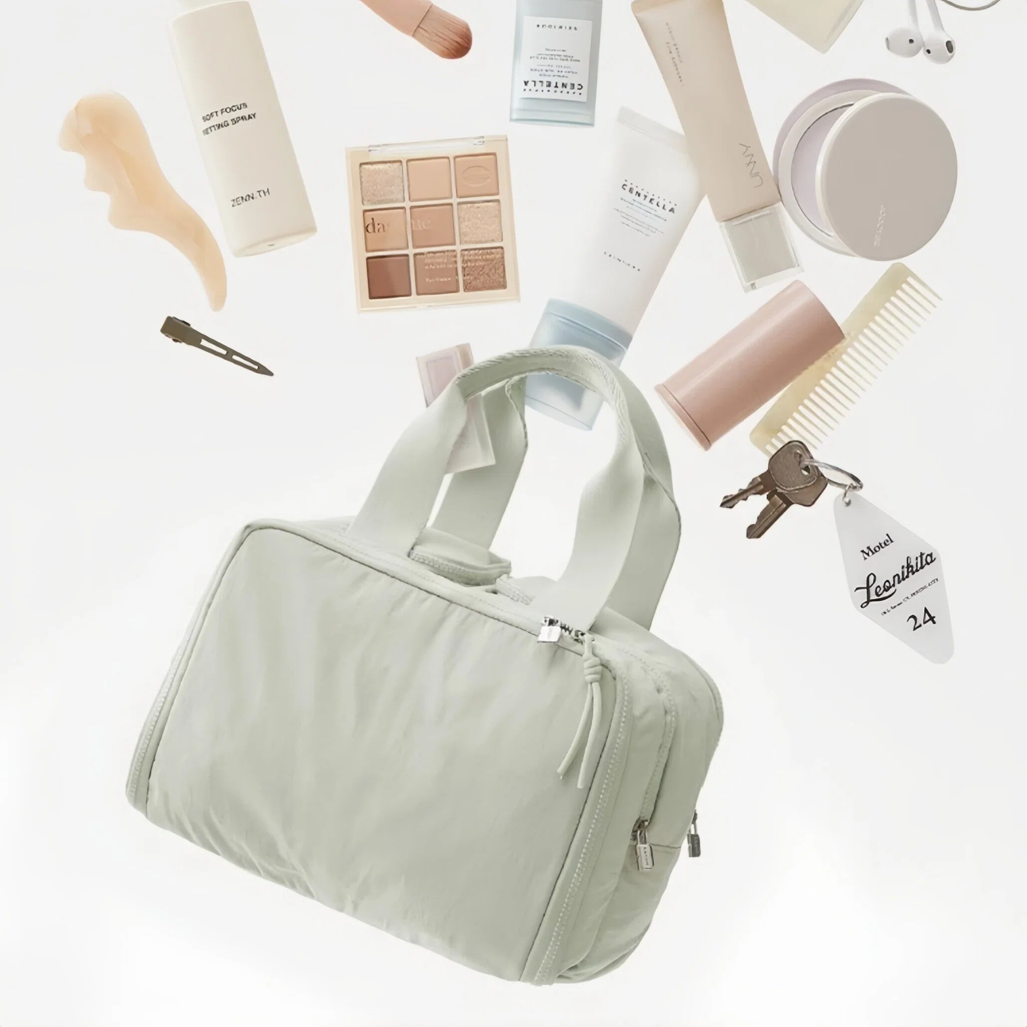 Light green travel bag surrounded by beauty products on a white background