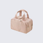 Pink travel bag with handles on a light gray background