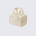 Beige toiletry bag with handles on a light gray background