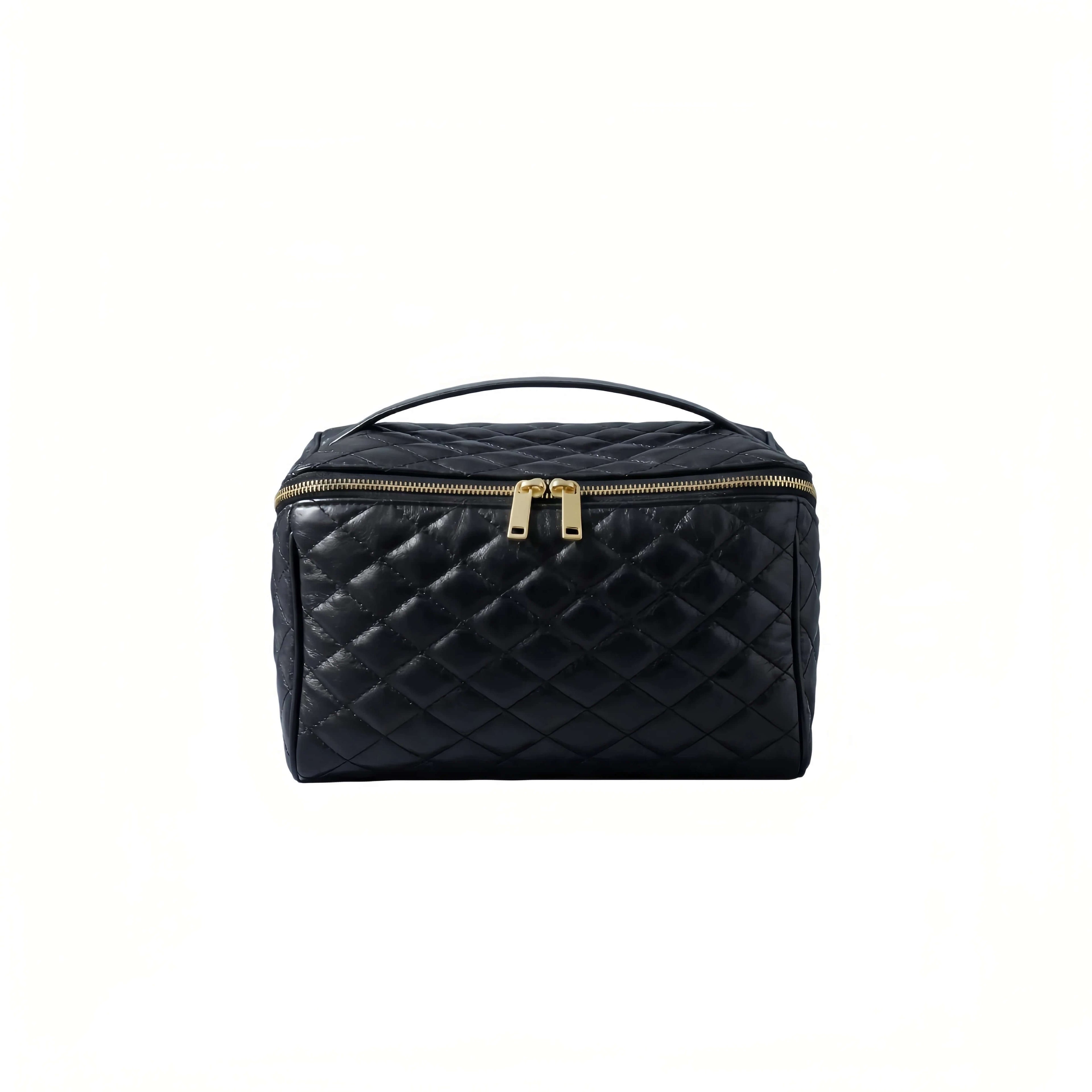 Black quilted cosmetic bag with gold zippers on a white background