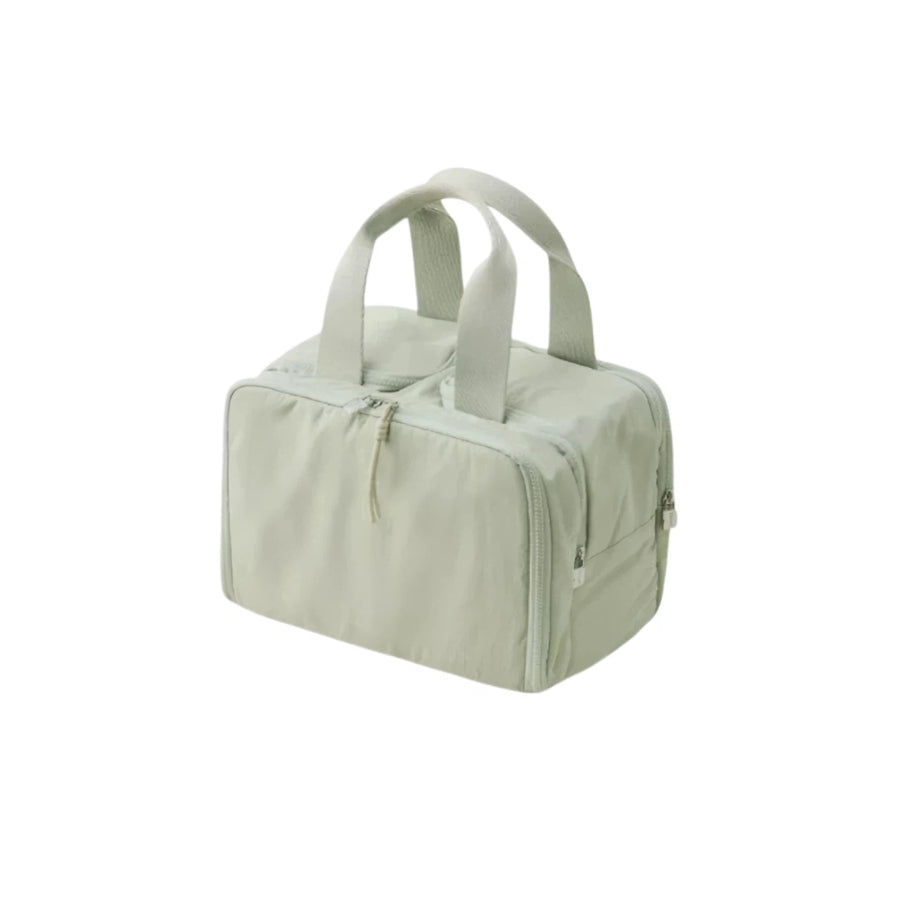 Light green travel bag with handles on a white background