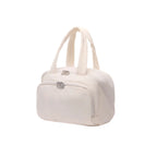 Ivory travel bag with a silver clasp on a white background