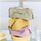 Stack of pastel-colored bags with bows on a light background