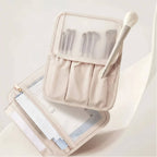 Beige makeup brush set in a transparent case on a light background