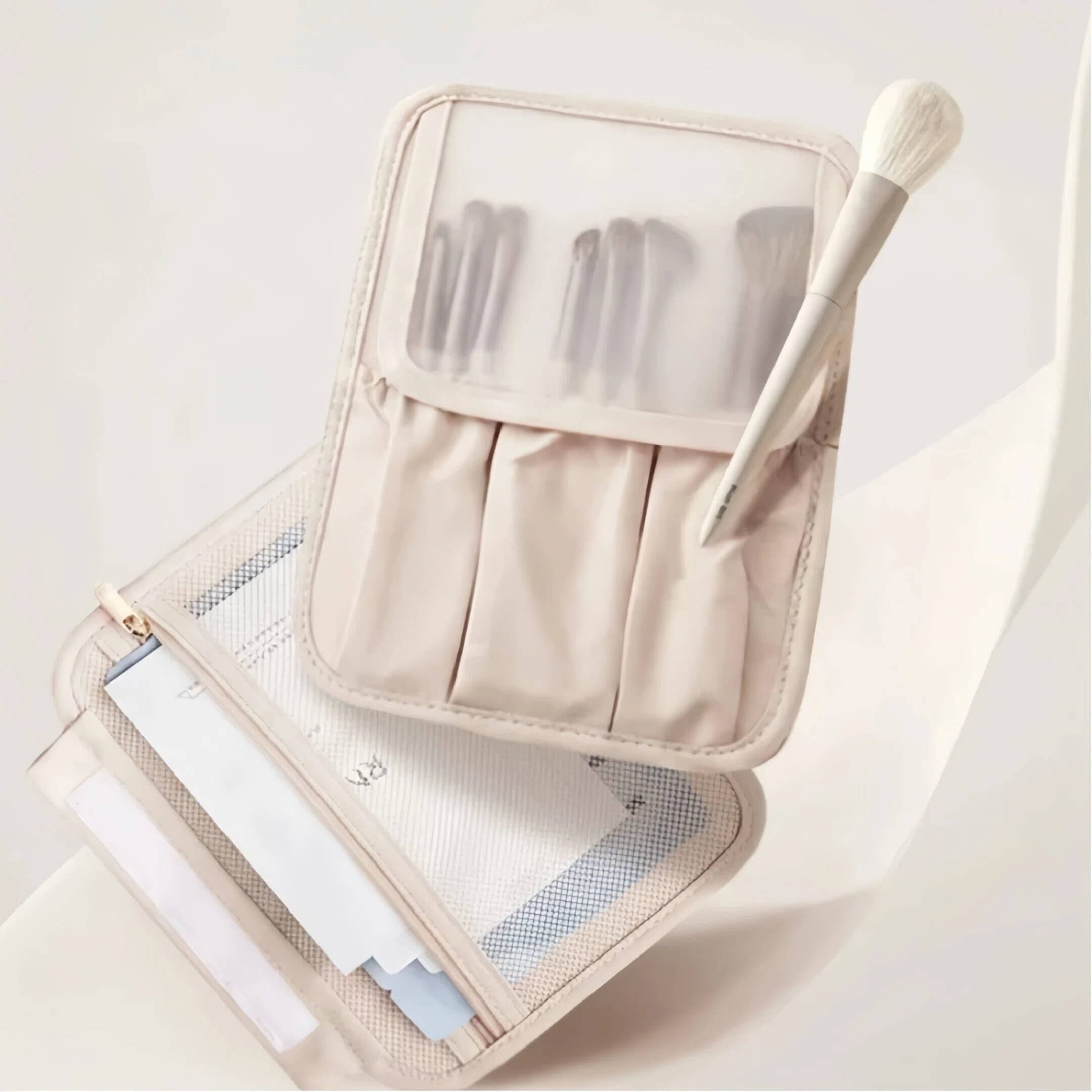 Beige makeup brush set in a transparent case on a light background