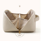 Beige cosmetic bag with open zipper on a white background