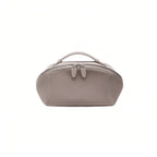 A dusty mauve cosmetic bag with a top handle and zippered closure, shown against a plain white background.