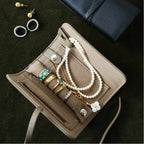Jewelry organizer with necklaces, rings, and earrings on a dark surface