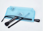 Blue travel storage bag with brushes on a white background