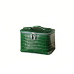 A green leather cosmetic bag with a top handle and silver zipper, shown on a plain white background.