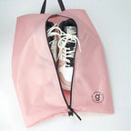 Pink shoe bag with a sneaker inside on a white background