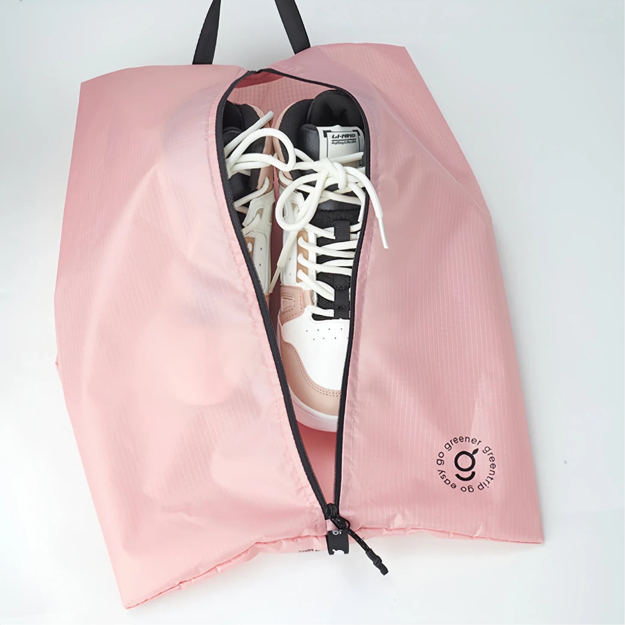 Pink shoe bag with a sneaker inside on a white background