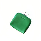 Green leather jewellery bag with a zipper on a white background