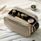 Beige cosmetic bag with cosmetic products on a light background