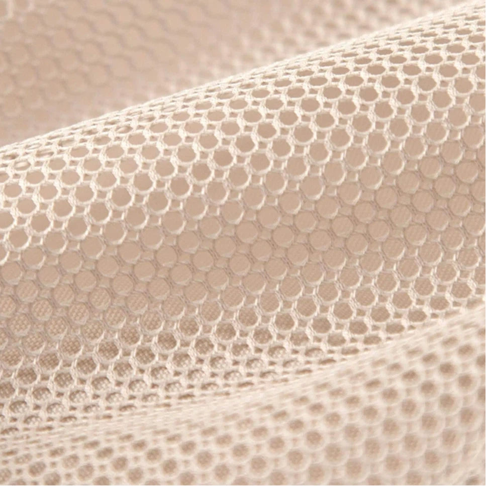 Close-up of beige textured fabric with a subtle pattern