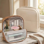 Beige and brown makeup bags with toiletries on a marble surface